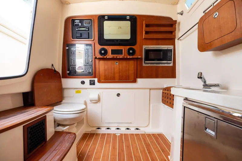 Slide: The Image of 2021 Grady-White Canyon 376 cabin interior with wood accents and modern amenities. - 36