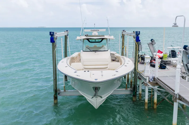 Slide: The Image of 2021 Grady-White Canyon 376 boat on lift, docked by the ocean. - 4