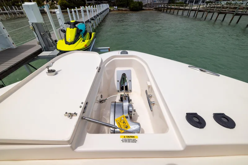 Slide: The Image of Bow view of 2021 Grady-White Canyon 376 with anchor system and docked jet ski. - 9