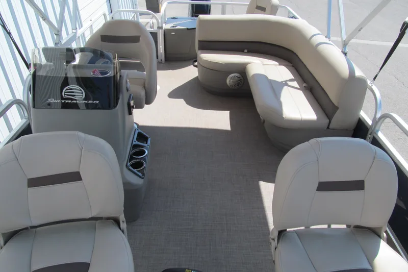 Slide: The Image of 2023 Sun Tracker Bass Buggy 18 DLX pontoon boat interior with seating and helm. - 11