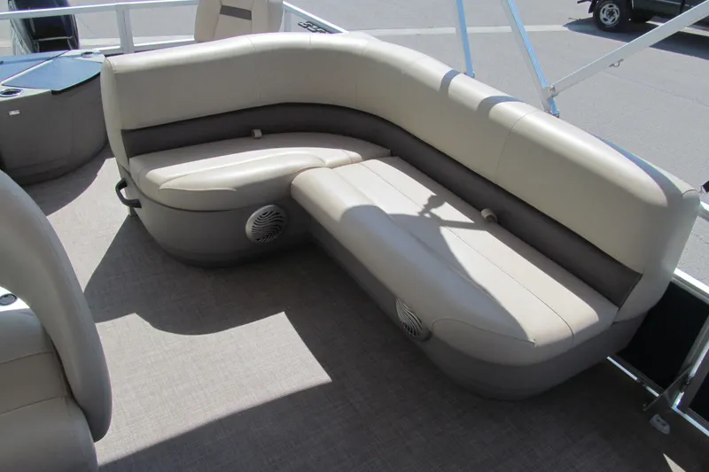 Slide: The Image of 2023 Sun Tracker Bass Buggy 18 DLX pontoon boat seating area with beige upholstery. - 13