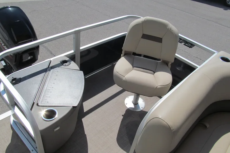 Slide: The Image of 2023 Sun Tracker Bass Buggy 18 DLX pontoon boat with beige seating and fishing station. - 14