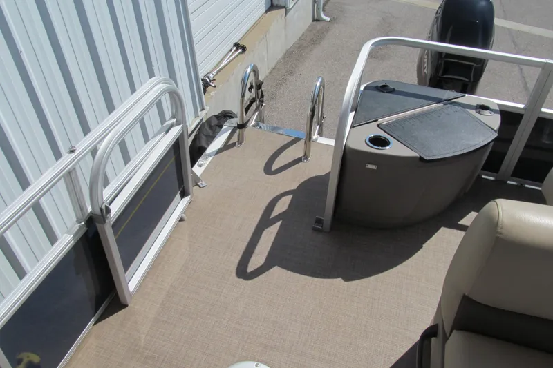 Slide: The Image of 2023 Sun Tracker Bass Buggy 18 DLX pontoon boat deck with seating and railing. - 15