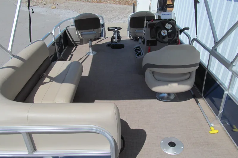 Slide: The Image of 2023 Sun Tracker Bass Buggy 18 DLX pontoon boat interior with seating and steering console. - 5