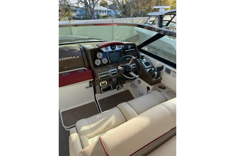 Slide: The Image of 2016 Formula 350 Crossover Bowrider I/O cockpit with steering wheel and control panel. - 12
