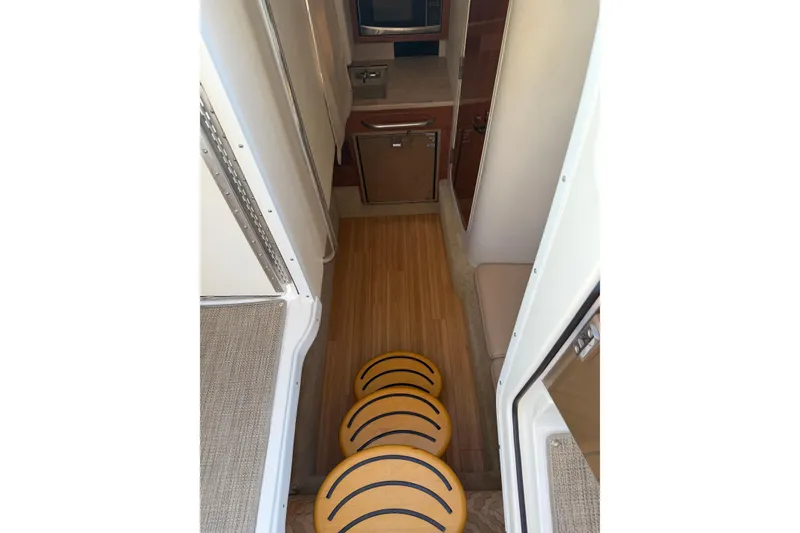 Slide: The Image of Interior view of 2016 Formula 350 Crossover Bowrider I/O with wooden flooring and compact kitchen. - 13