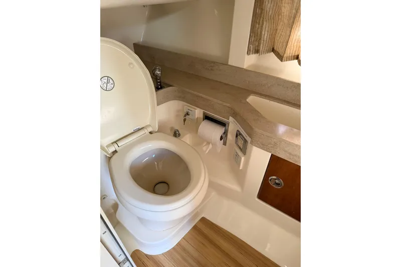 Slide: The Image of 2016 Formula 350 Crossover Bowrider I/O bathroom with toilet and sink. - 14