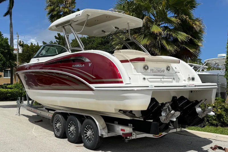 Slide: The Image of 2019 Formula 350 Crossover Bowrider I/O on trailer, parked outdoors. - 2