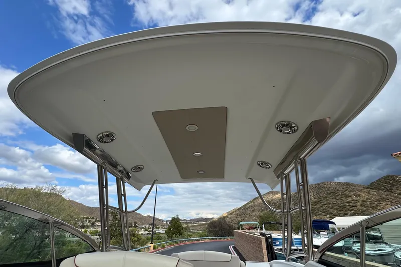 Slide: The Image of 2016 Formula 350 Crossover Bowrider I/O boat canopy with scenic mountain backdrop. - 24
