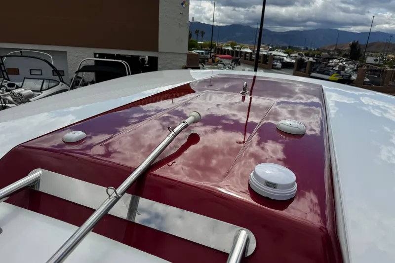 Slide: The Image of 2016 Formula 350 Crossover Bowrider I/O with sleek red deck and chrome accents. - 27