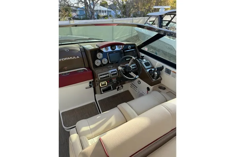 Slide: The Image of 2016 Formula 350 Crossover Bowrider I/O cockpit with steering wheel and control panel. - 3