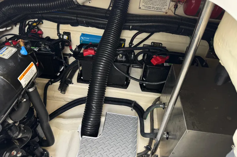 Slide: The Image of Engine compartment of a 2016 Formula 350 Crossover Bowrider I/O, showcasing batteries and wiring. - 35