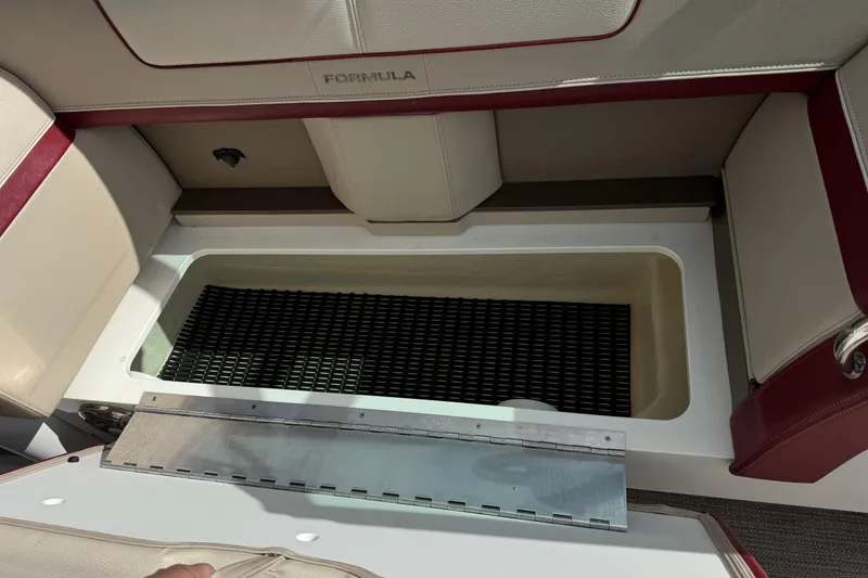Slide: The Image of 2016 Formula 350 Crossover Bowrider I/O storage compartment with open lid and seating. - 45