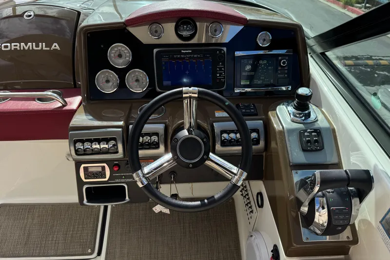 Slide: The Image of 2016 Formula 350 Crossover Bowrider I/O dashboard with steering wheel and control panels. - 49