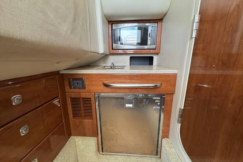 Slide: The Image of 2016 Formula 350 Crossover Bowrider I/O cabin with kitchenette, microwave, and fridge. - 59
