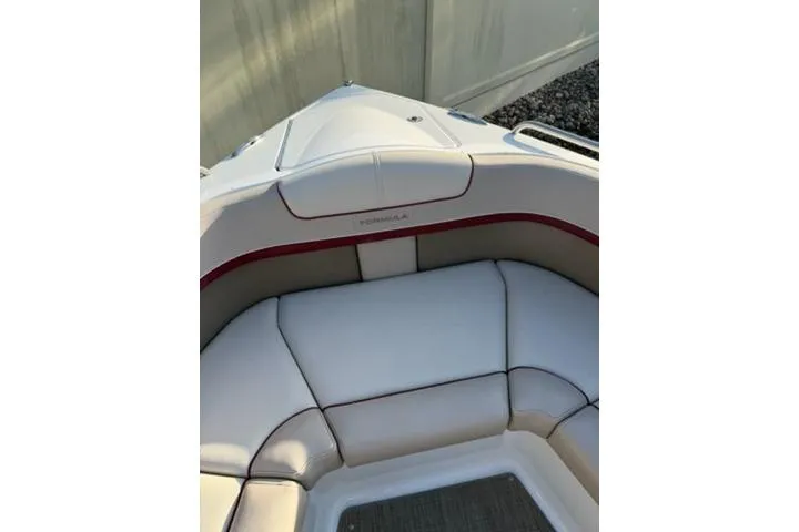 Slide: The Image of 2016 Formula 350 Crossover Bowrider I/O with white and red cushioned seating. - 7