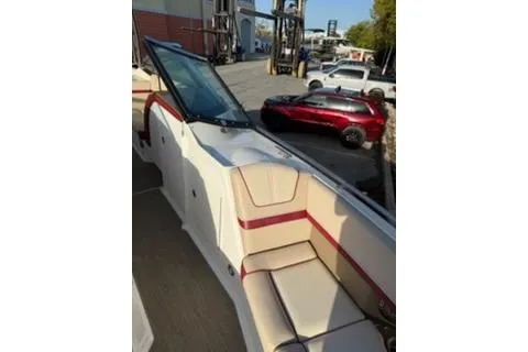Slide: The Image of 2016 Formula 350 Crossover Bowrider I/O with beige and red interior, docked outdoors. - 9