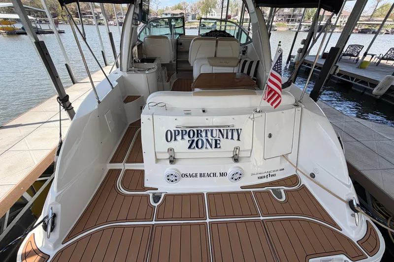 Slide: The Image of 2008 Sea Ray Sundancer 330 docked, featuring "Opportunity Zone" nameplate and American flag. - 11