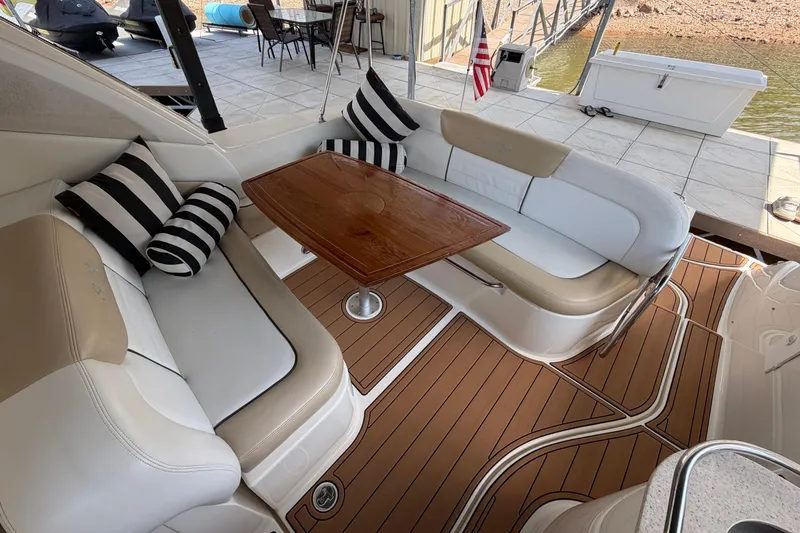 Slide: The Image of Interior of 2008 Sea Ray Sundancer 330 with cushioned seating and wooden table. - 12