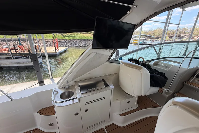 Slide: The Image of Interior of 2008 Sea Ray Sundancer 330 yacht with sink, seating, and dockside view. - 13