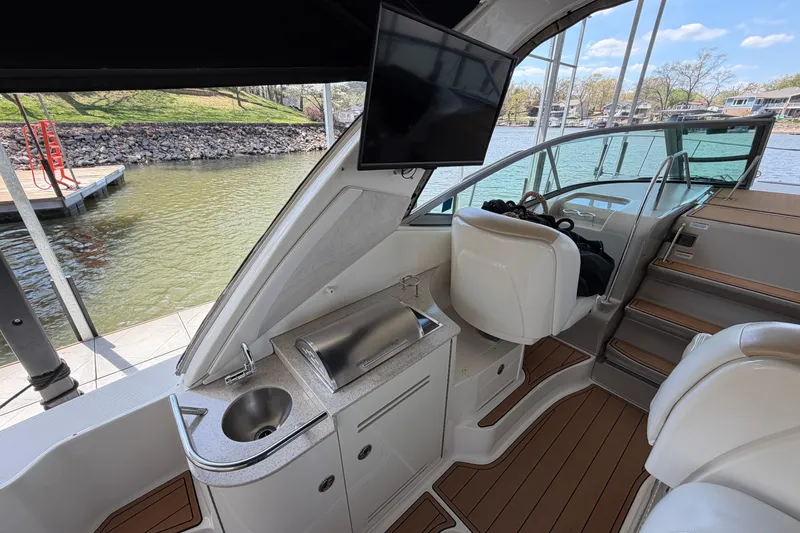 Slide: The Image of Interior of 2008 Sea Ray Sundancer 330 yacht with helm, sink, and seating area. - 14