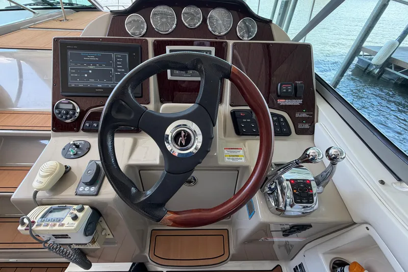 Slide: The Image of 2008 Sea Ray Sundancer 330 helm with steering wheel, controls, and navigation displays. - 17