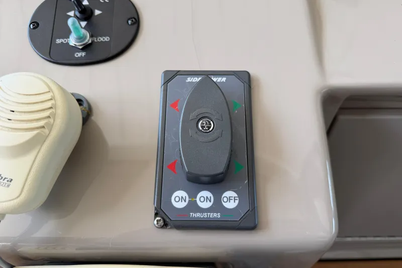 Slide: The Image of Control panel of a 2008 Sea Ray Sundancer 330 boat with thruster controls. - 19