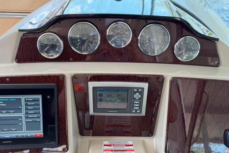 Slide: The Image of Dashboard of a 2008 Sea Ray Sundancer 330 with gauges and navigation controls. - 20