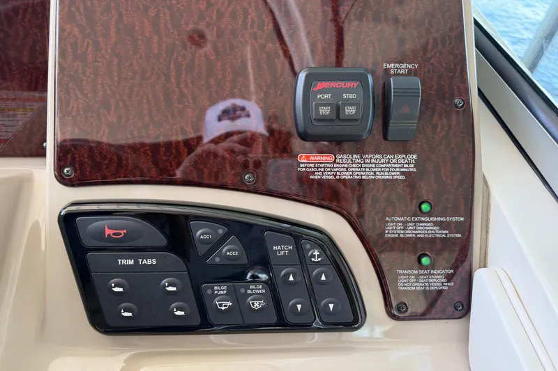 Slide: The Image of Control panel of a 2008 Sea Ray Sundancer 330 boat with various switches and indicators. - 23