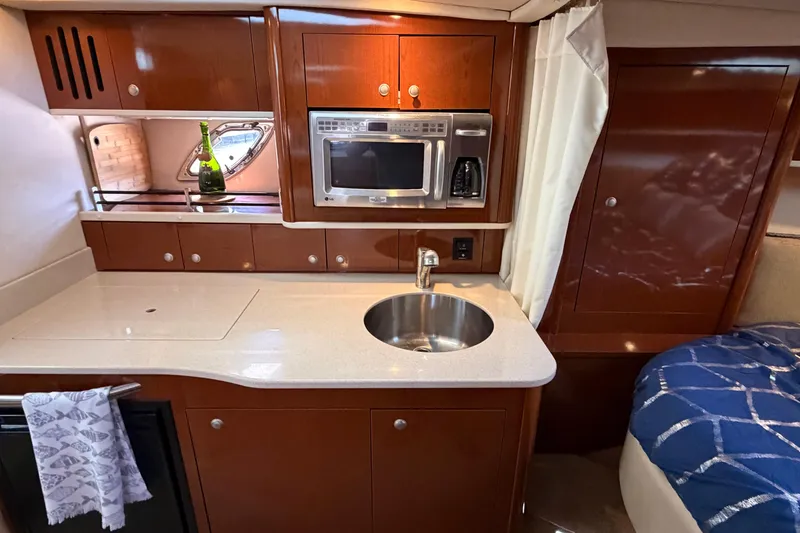 Slide: The Image of 2008 Sea Ray Sundancer 330 yacht interior with kitchenette, microwave, and sink. - 26