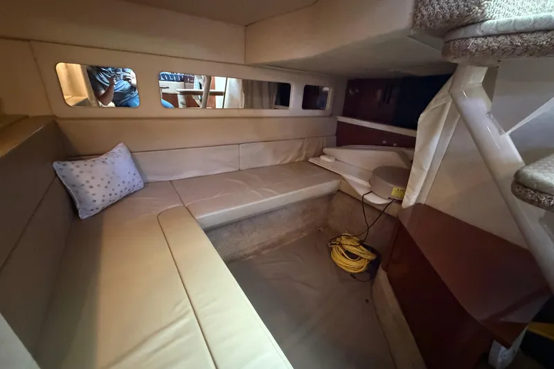 Slide: The Image of Interior cabin of 2008 Sea Ray Sundancer 330 with beige seating and a small window. - 27