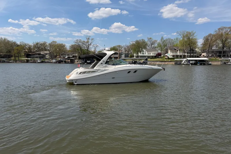 Slide: The Image of 2008 Sea Ray Sundancer 330 yacht cruising on a calm lake under a blue sky. - 3