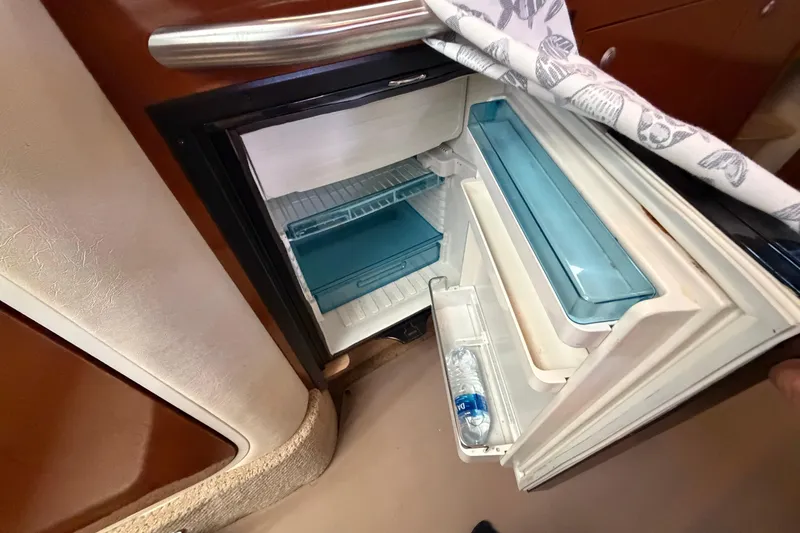 Slide: The Image of Open refrigerator inside a 2008 Sea Ray Sundancer 330 yacht, showcasing storage compartments. - 31