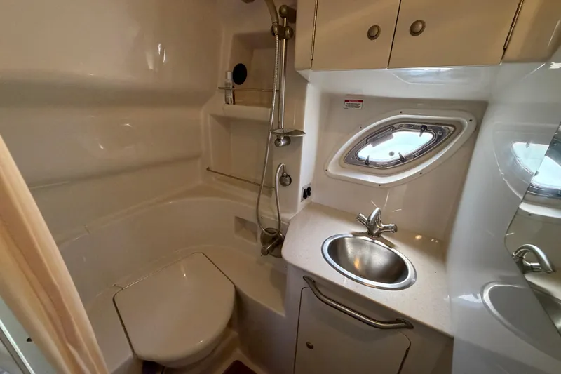 Slide: The Image of 2008 Sea Ray Sundancer 330 bathroom with sink, toilet, and porthole window. - 35