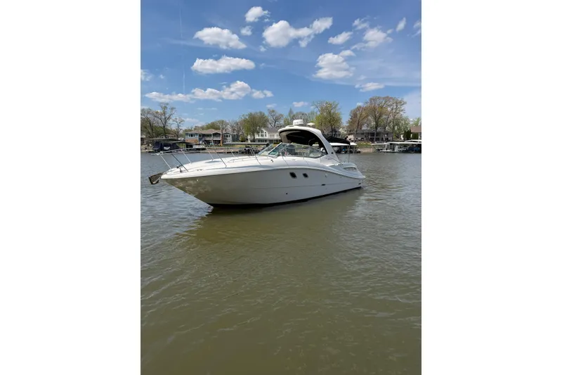 Slide: The Image of 2008 Sea Ray Sundancer 330 yacht on calm water under a clear blue sky. - 4