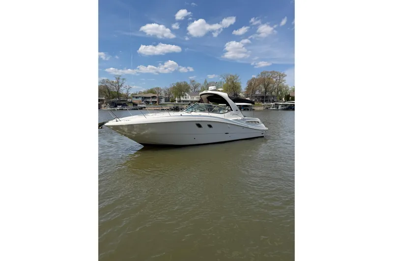 Slide: The Image of 2008 Sea Ray Sundancer 330 yacht on calm water under a clear blue sky. - 5