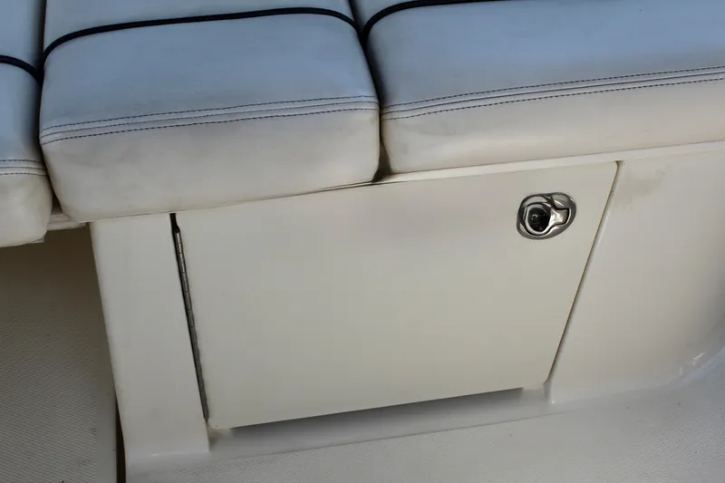 Slide: The Image of White cushioned seating with storage compartment on 2011 Sea Ray Sundancer 260 boat. - 14