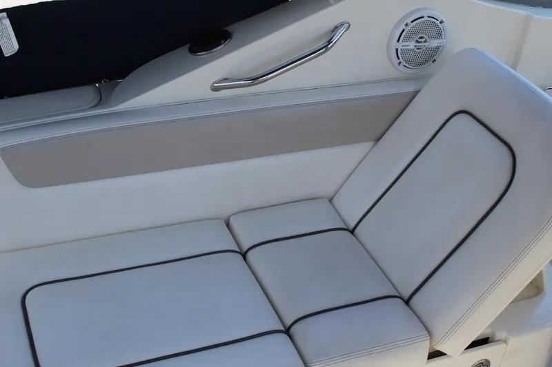 Slide: The Image of Luxurious seating on a 2011 Sea Ray Sundancer 260 boat, featuring white upholstery. - 16