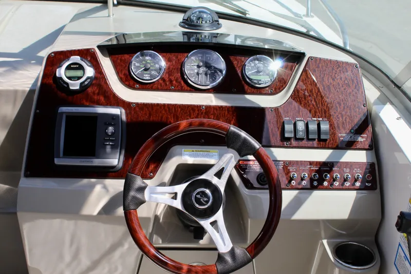 Slide: The Image of Dashboard of a 2011 Sea Ray Sundancer 260 boat with steering wheel and gauges. - 17