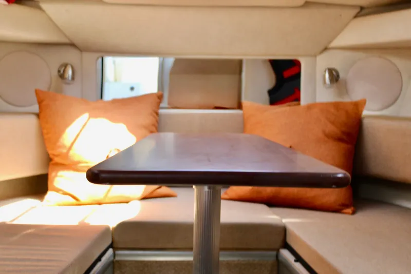 Slide: The Image of Interior of 2011 Sea Ray Sundancer 260 with cozy seating and table. - 24