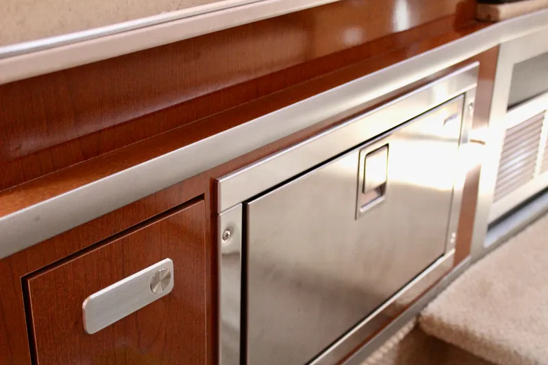 Slide: The Image of Interior of 2011 Sea Ray Sundancer 260 with wood and stainless steel cabinetry. - 25
