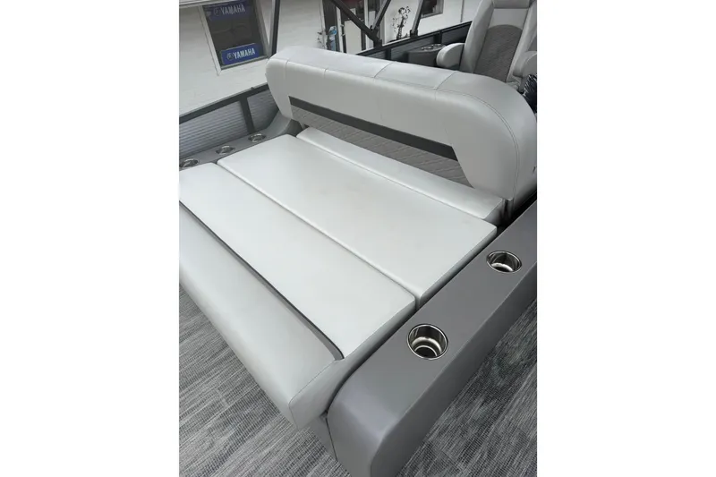 Slide: The Image of Luxurious seating on 2026 Qwest L-Class Splash Pad 24 boat with cup holders. - 12