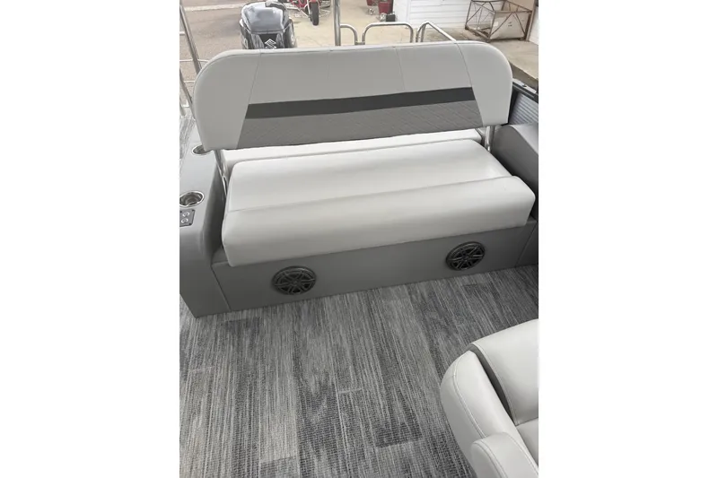 Slide: The Image of Interior of 2026 Qwest L-Class Splash Pad 24 boat with gray seating and flooring. - 13