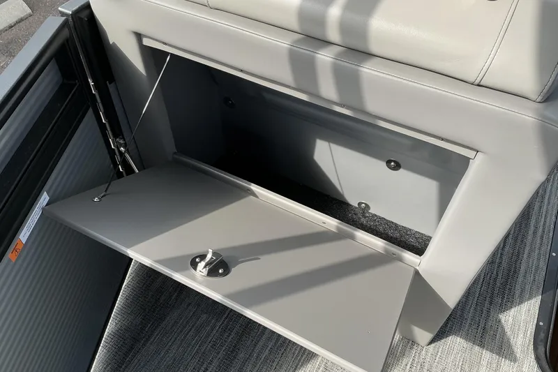 Slide: The Image of Open storage compartment in 2026 Qwest L-Class Splash Pad 24 boat. - 16