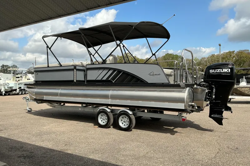 Slide: The Image of 2026 Qwest L-Class Splash Pad 24 pontoon boat with Suzuki outboard motor on trailer. - 4