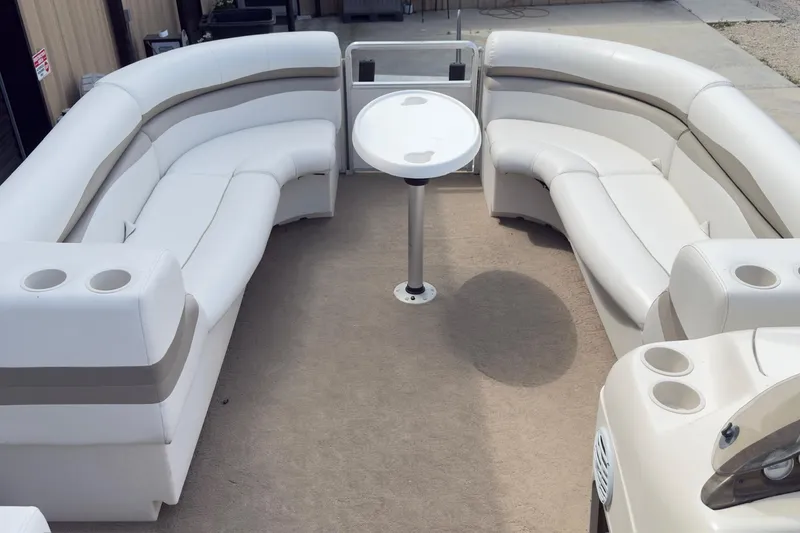 Slide: The Image of Interior of a 2007 Harris Sunliner 220 pontoon boat with white seating and table. - 11