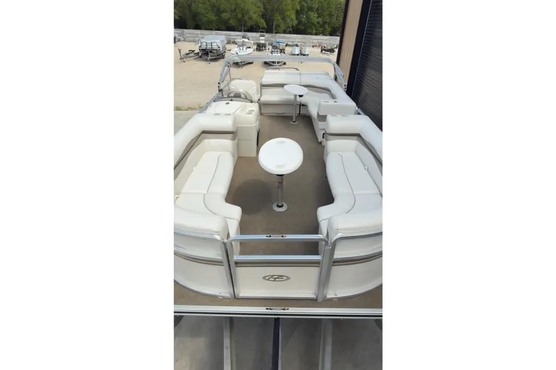 Slide: The Image of 2007 Harris Sunliner 220 pontoon boat with spacious seating and white upholstery. - 12