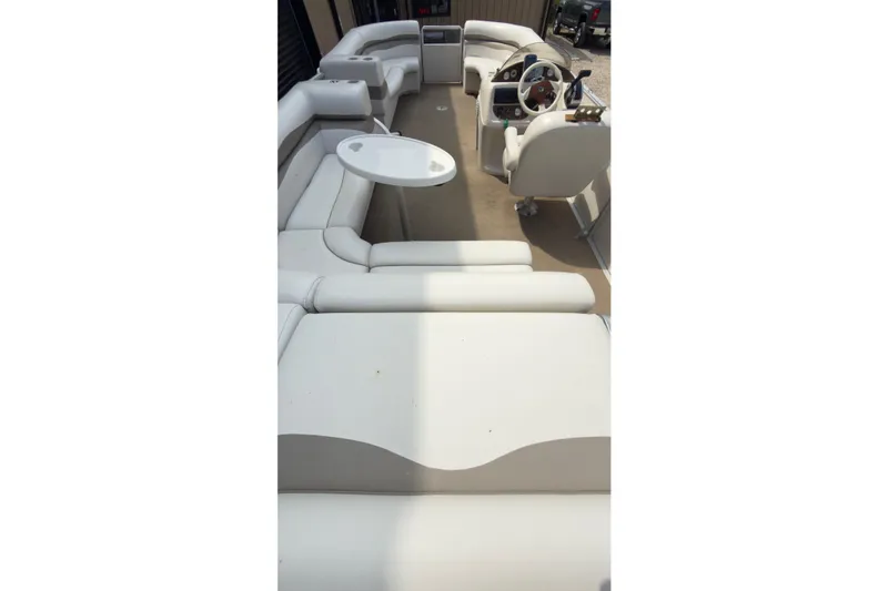 Slide: The Image of 2007 Harris Sunliner 220 pontoon boat interior with white seating and steering console. - 6