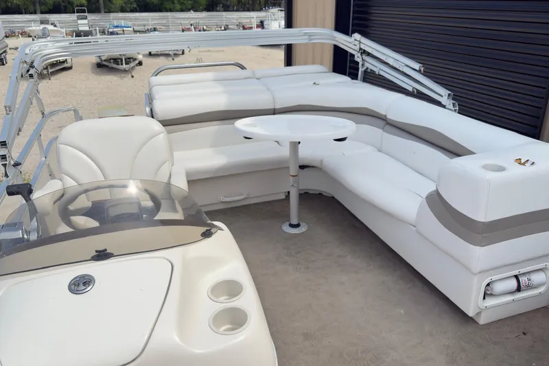Slide: The Image of 2007 Harris Sunliner 220 pontoon boat interior with white seating and table. - 7
