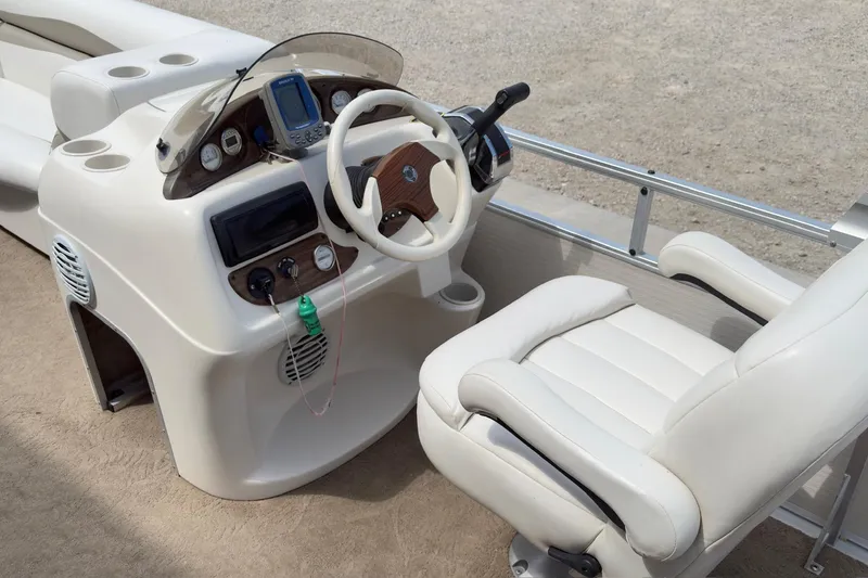 Slide: The Image of 2007 Harris Sunliner 220 boat helm with steering wheel and control panel. - 8